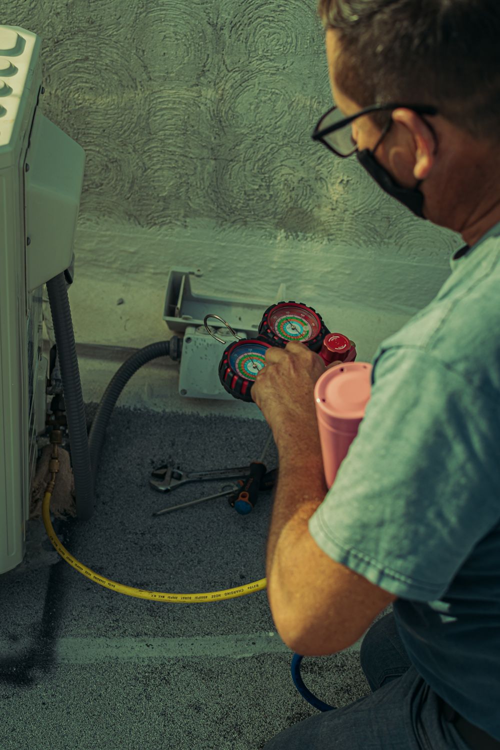 HVAC technician repairing residential heating and cooling equipment