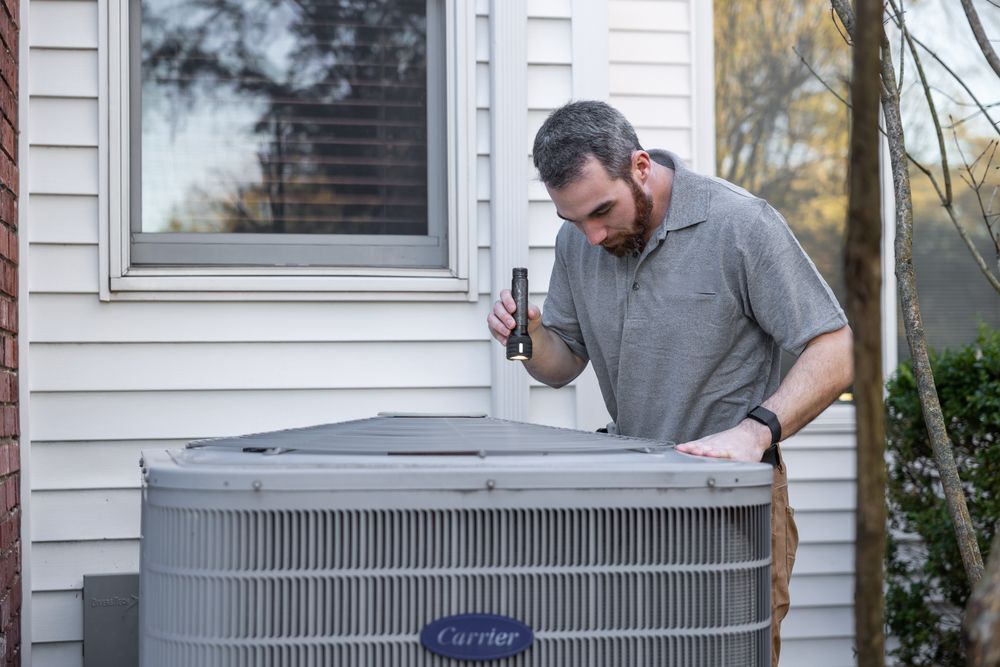 Technician preparing HVAC replacement equipment for installation